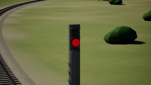 Signal post with a red light beside a curving railway track and bushes.